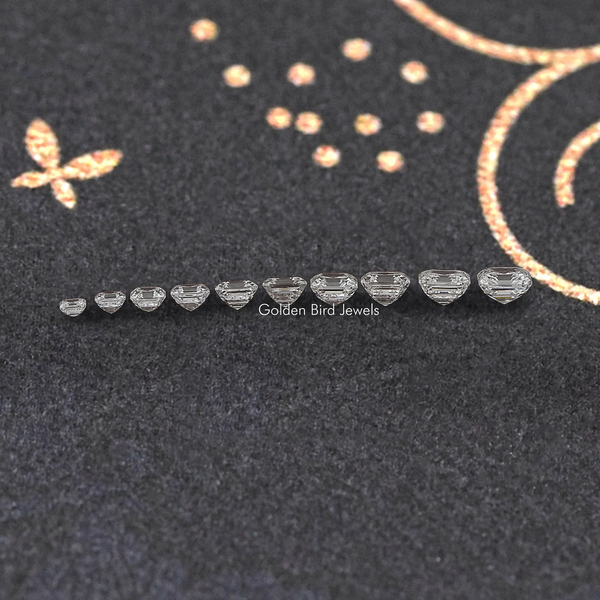 Asscher-cut lab diamonds arranged in a line on dark jewelry display fabric