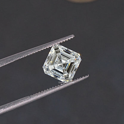Asscher-cut colorless moissanite loose stone held between tweezers, profile angle