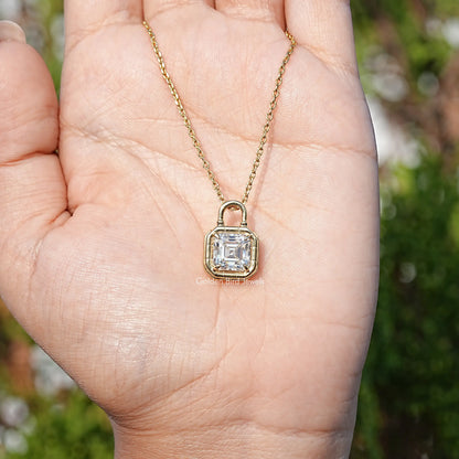 Asscher-cut moissanite solitaire pendant shown in open palm on a gold-tone chain