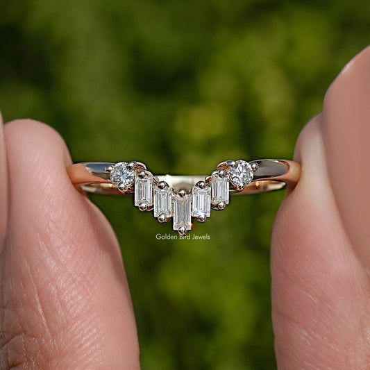Curved wedding band ring with baguette-cut stones and small round accents, gold-tone metal