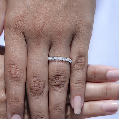 Stacked hand view with silver-toned half eternity baguette-cut moissanite band