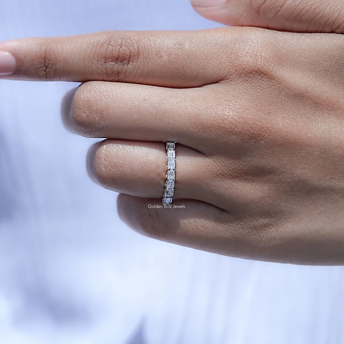 Silver-toned half eternity wedding band with baguette-cut moissanite stones