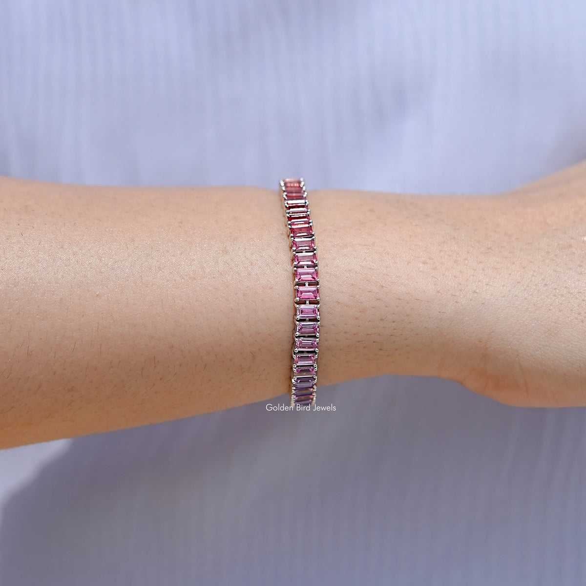 925 silver tennis bracelet with pink-red baguette gemstones on wrist