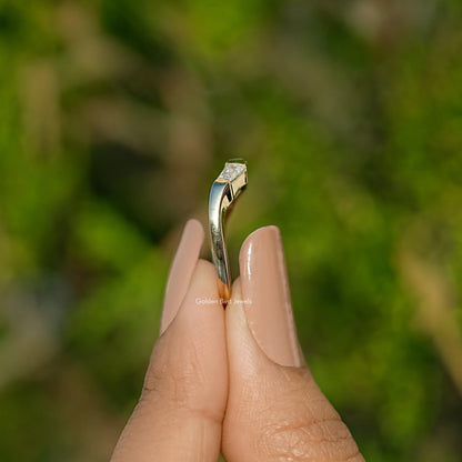 Side view of three-stone baguette-cut moissanite ring with raised prongs