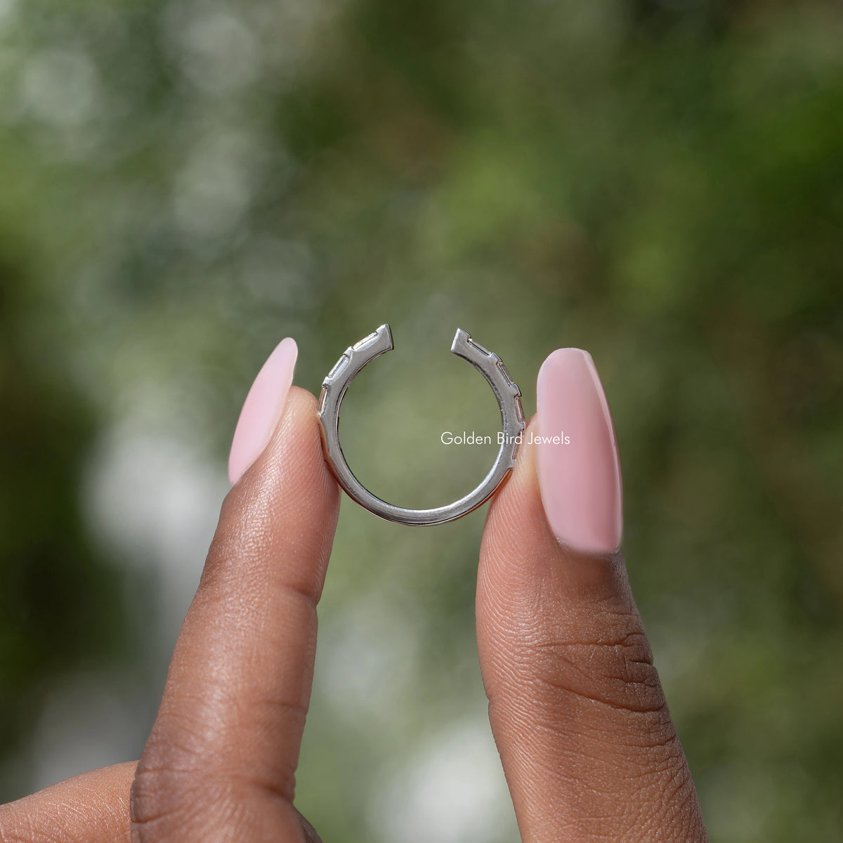 Silver open-gap proposal band ring viewed from side, baguette stones visible