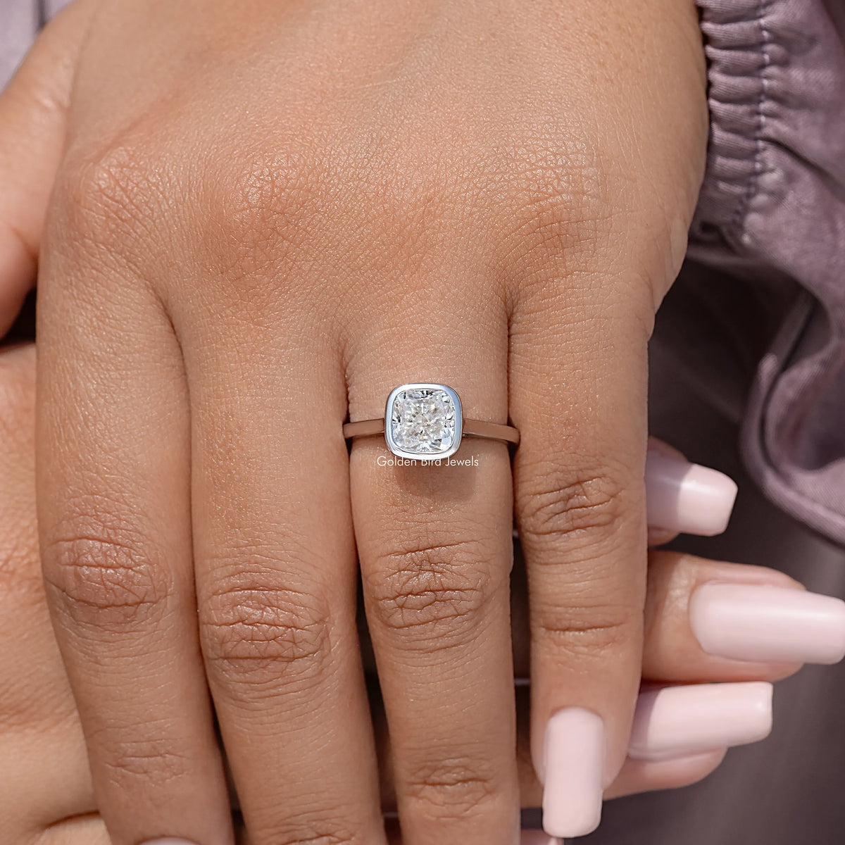 925 sterling silver cushion-cut moissanite bezel promise ring on open hand