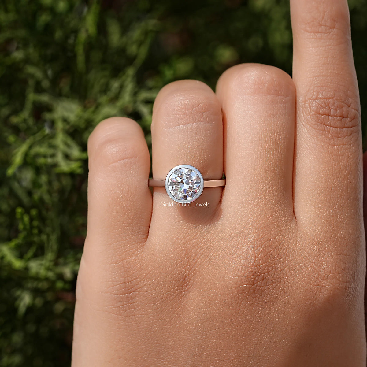 Sterling silver round moissanite bezel wedding ring, round stone on finger