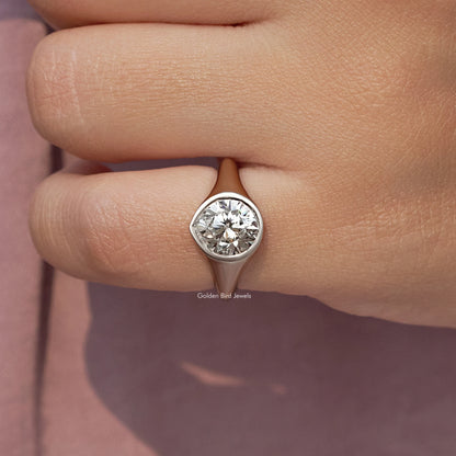 Silver bezel-set diamond engagement ring, round center view on finger close-up