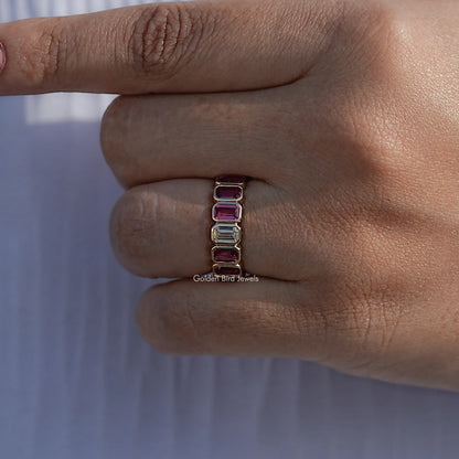 Bezel-set eternity band with rectangular gemstones on finger, side view close-up