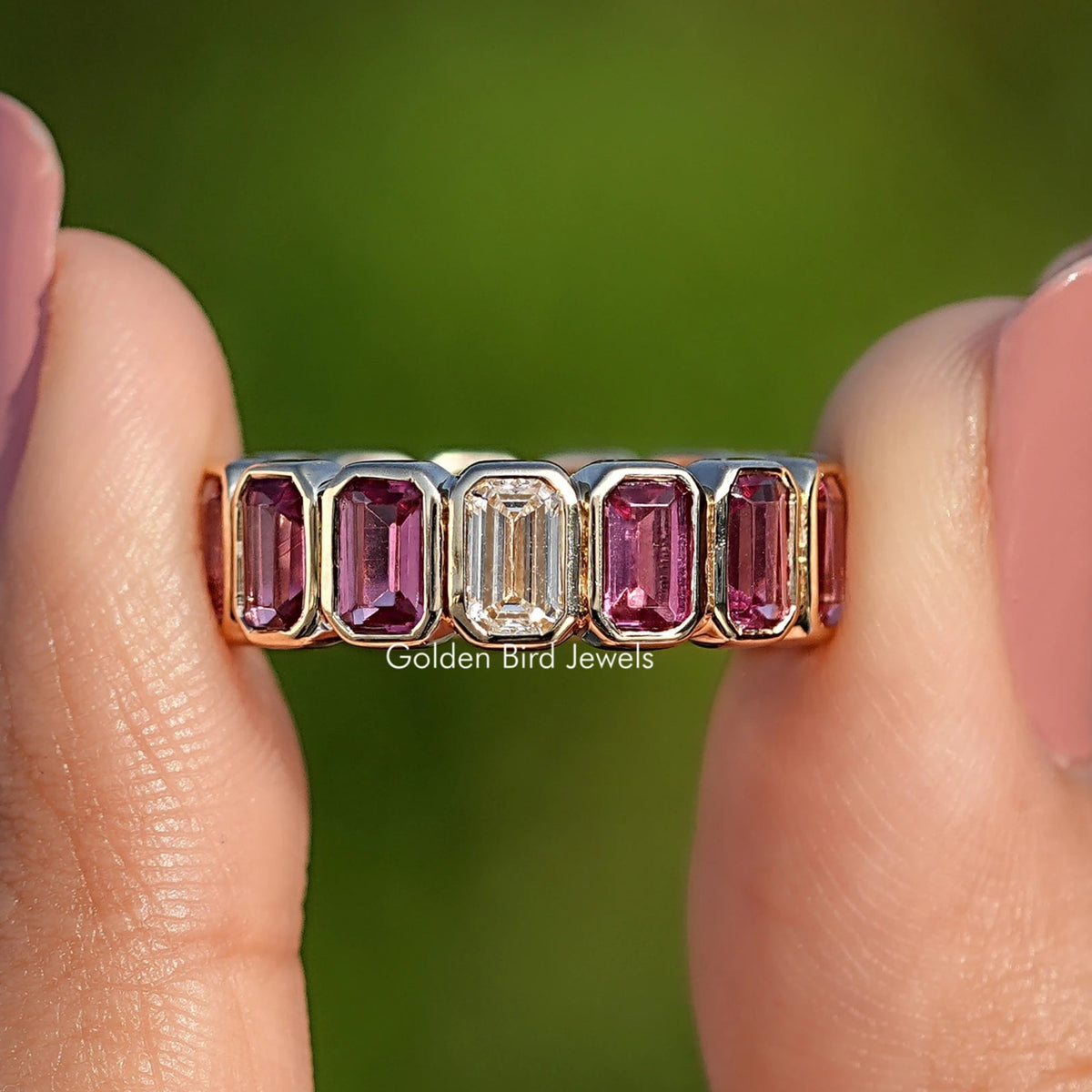 Bezel-set eternity band showing rectangular gemstones in a metal row