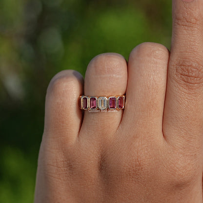 Bezel-set gemstone eternity ring with rectangular stones, worn on a hand