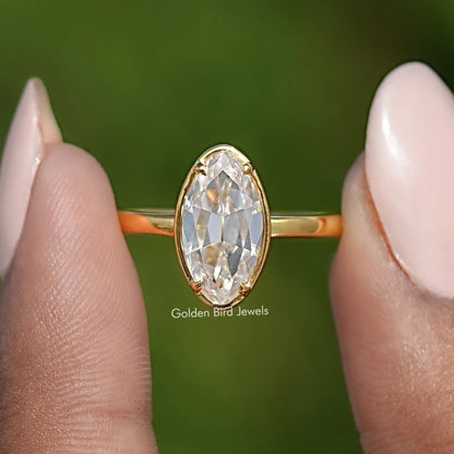 Front view of oval bezel-set moissanite ring, gold band