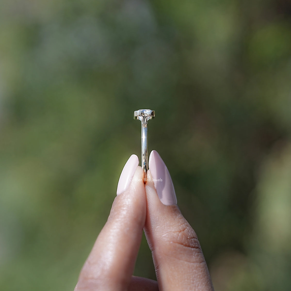 Top view of gold-toned solitaire ring featuring radiant-cut moissanite center stone