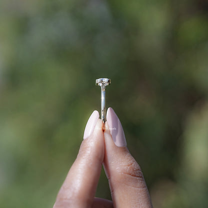 Top view of gold-toned solitaire ring featuring radiant-cut moissanite center stone