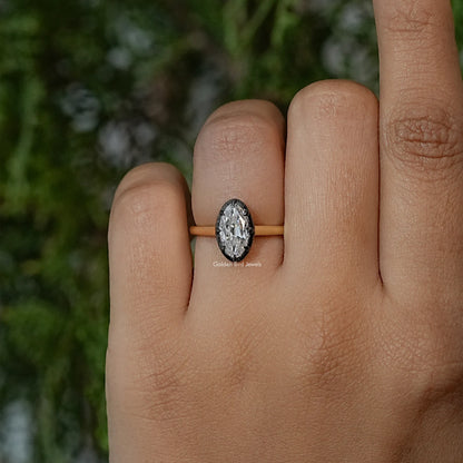 Oval moissanite solitaire ring with bezel setting on gold-tone band, front view