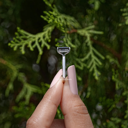 Silver ring top view with square black radiant-cut center stone and halo detail