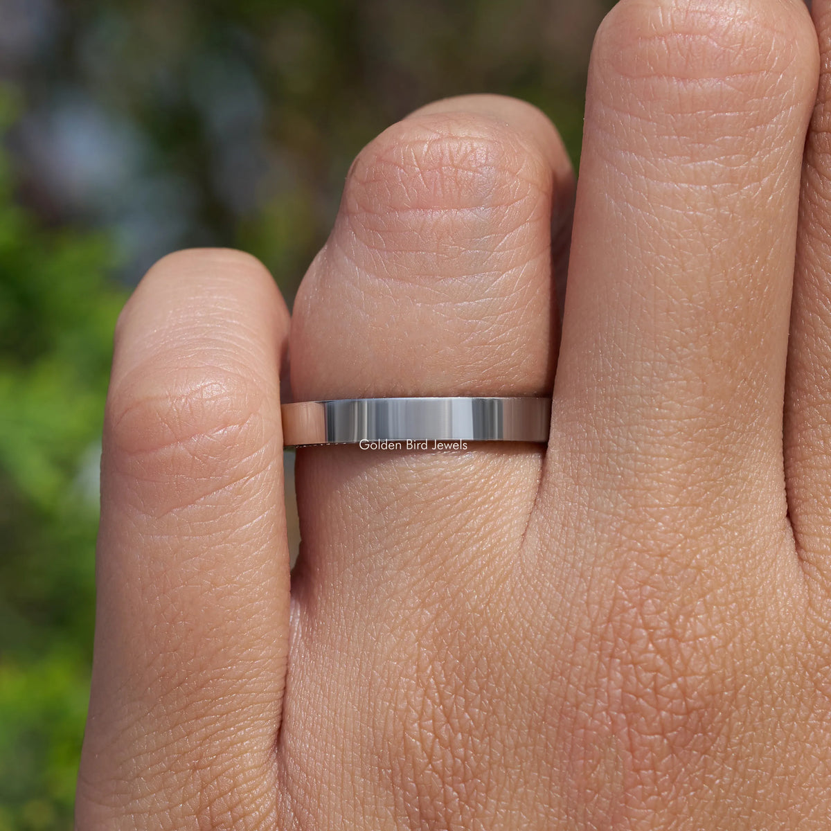 Silver-tone channel-set ring band with small round stones, worn on finger