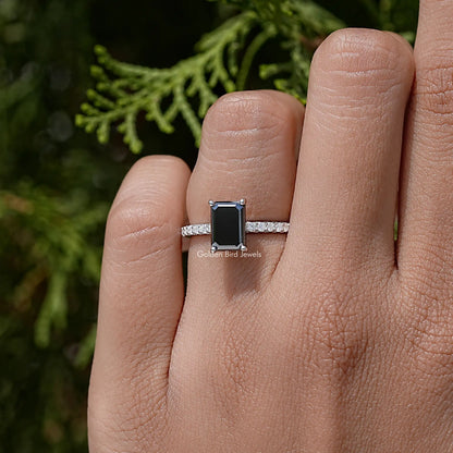Black emerald-cut moissanite accent ring in sterling silver on a hand