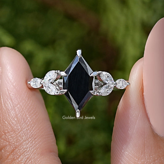 Close-up of silver ring: marquise black center with leaf prong setting