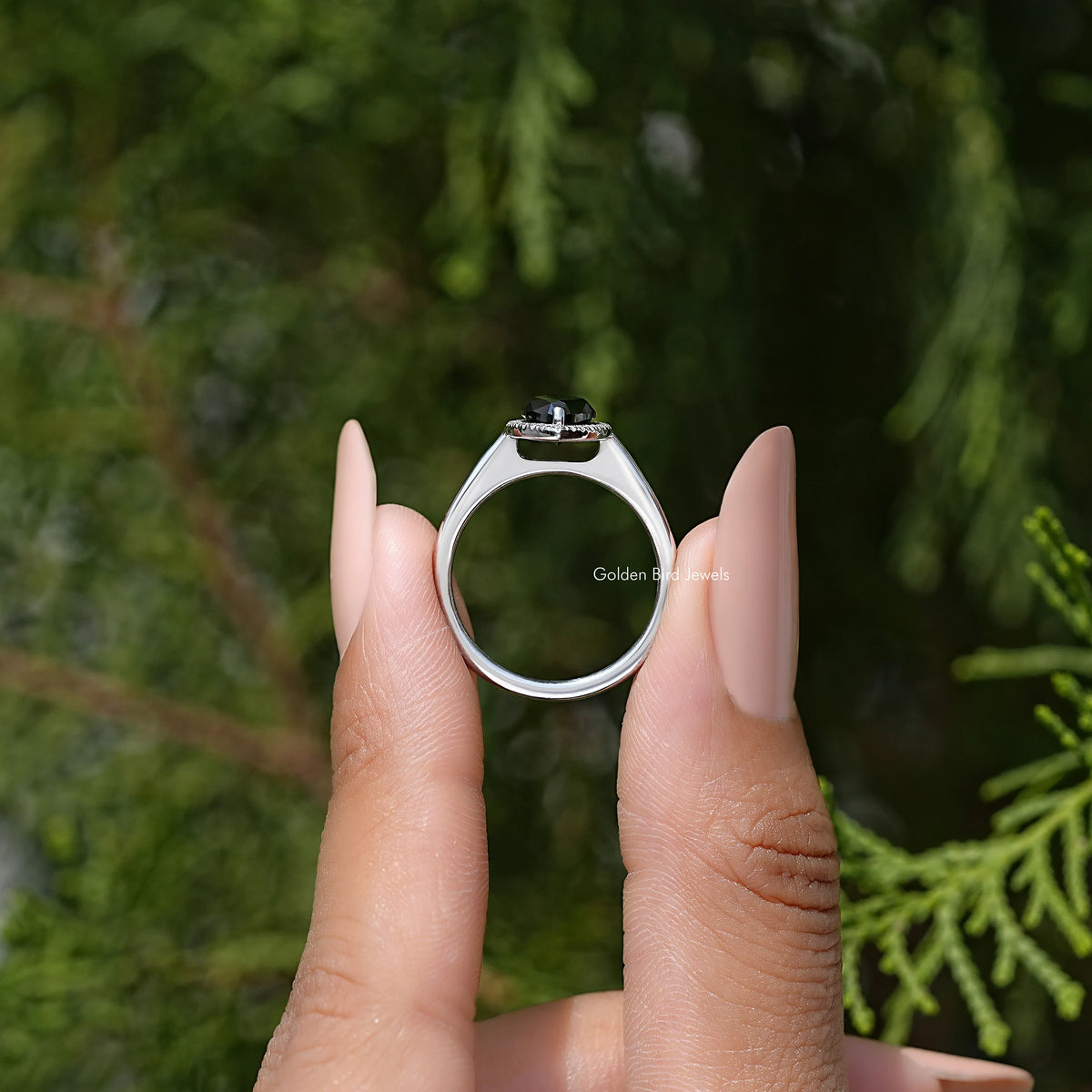 Sterling silver halo ring with marquise dark center stone, front view