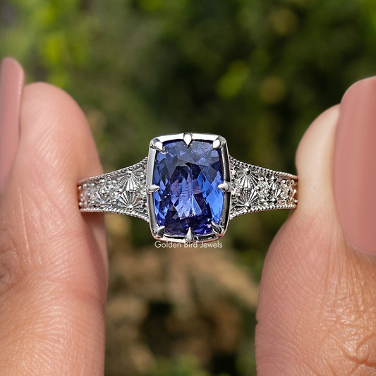 Blue tanzanite cushion-cut ring with filigree silver band
