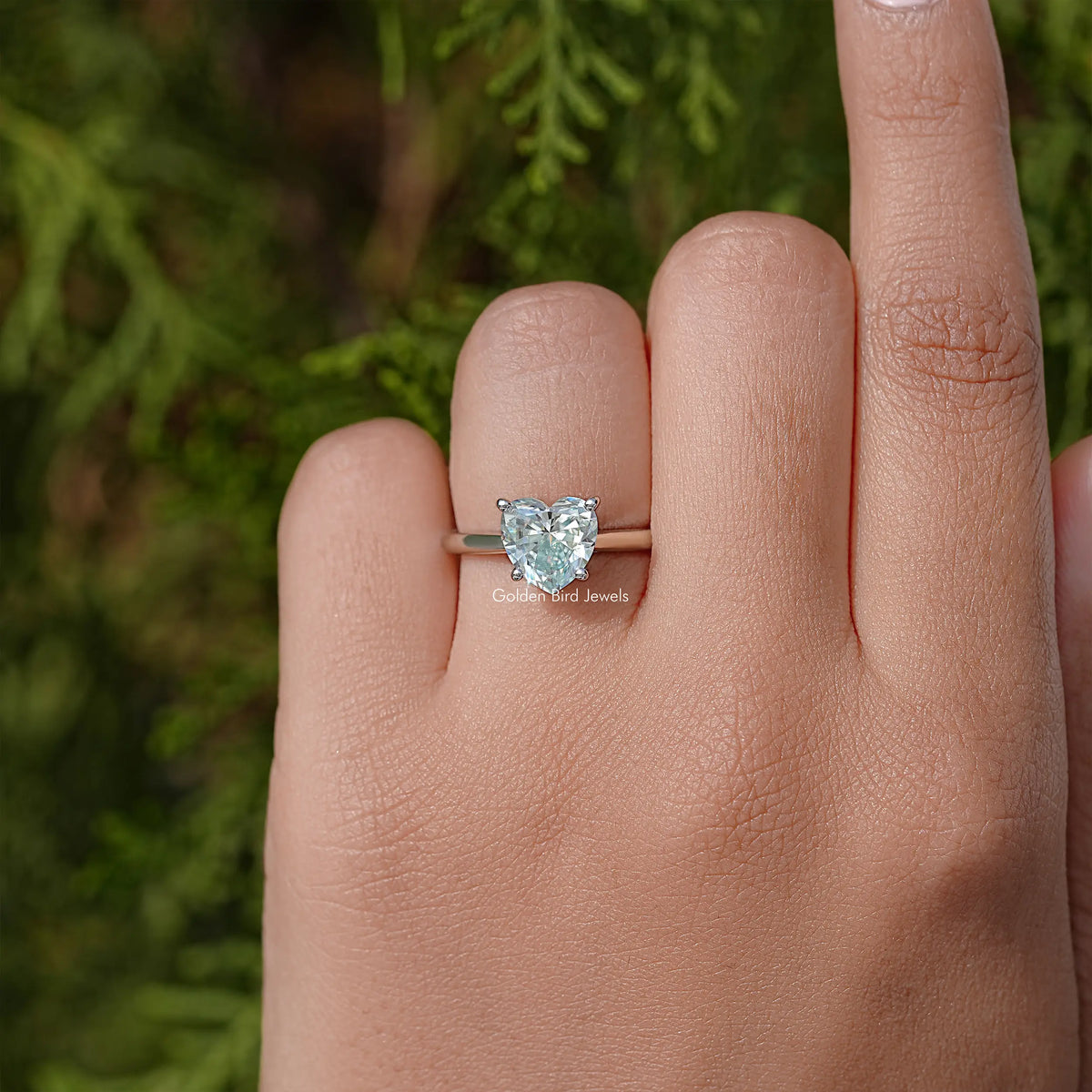 Sterling silver ring with solitaire faceted gemstone displayed on hand