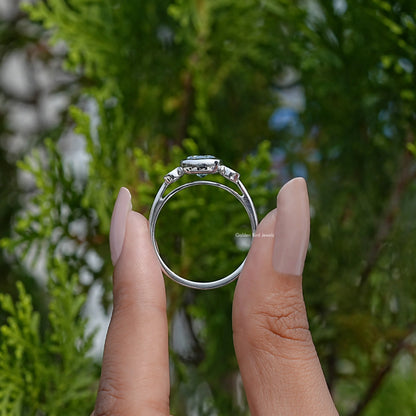 Back view of three-stone cushion-cut moissanite engagement ring on fingers