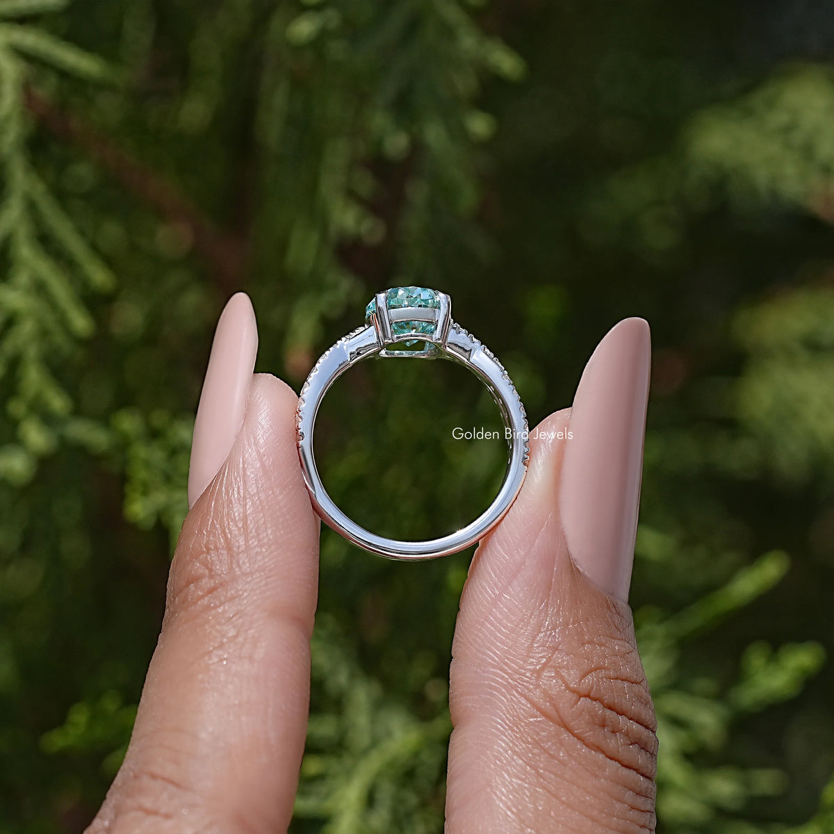Sterling silver ring viewed from the back with oval blue stone and pave band