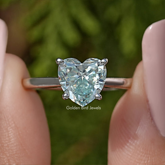 Close-up of sterling silver solitaire ring with large faceted gemstone and prongs