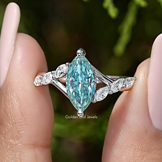 Close-up floral sterling silver wedding ring with teal marquise center stone