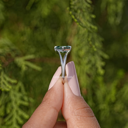 Sterling silver split shank ring with teal Asscher cut moissanite, side view
