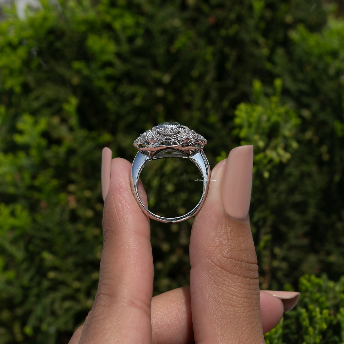 Vintage halo ring with round-cut blue moissanite and ornate sterling silver setting