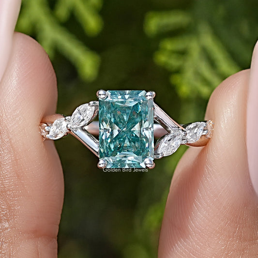 Sterling silver ring with teal emerald-cut center and marquise side stones