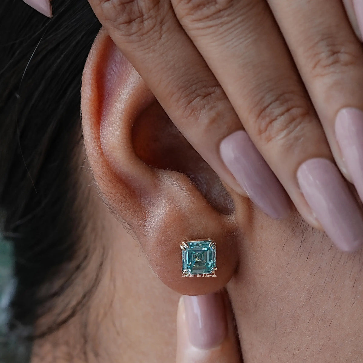 Detailed view of moissanite earrings in secure setting 
