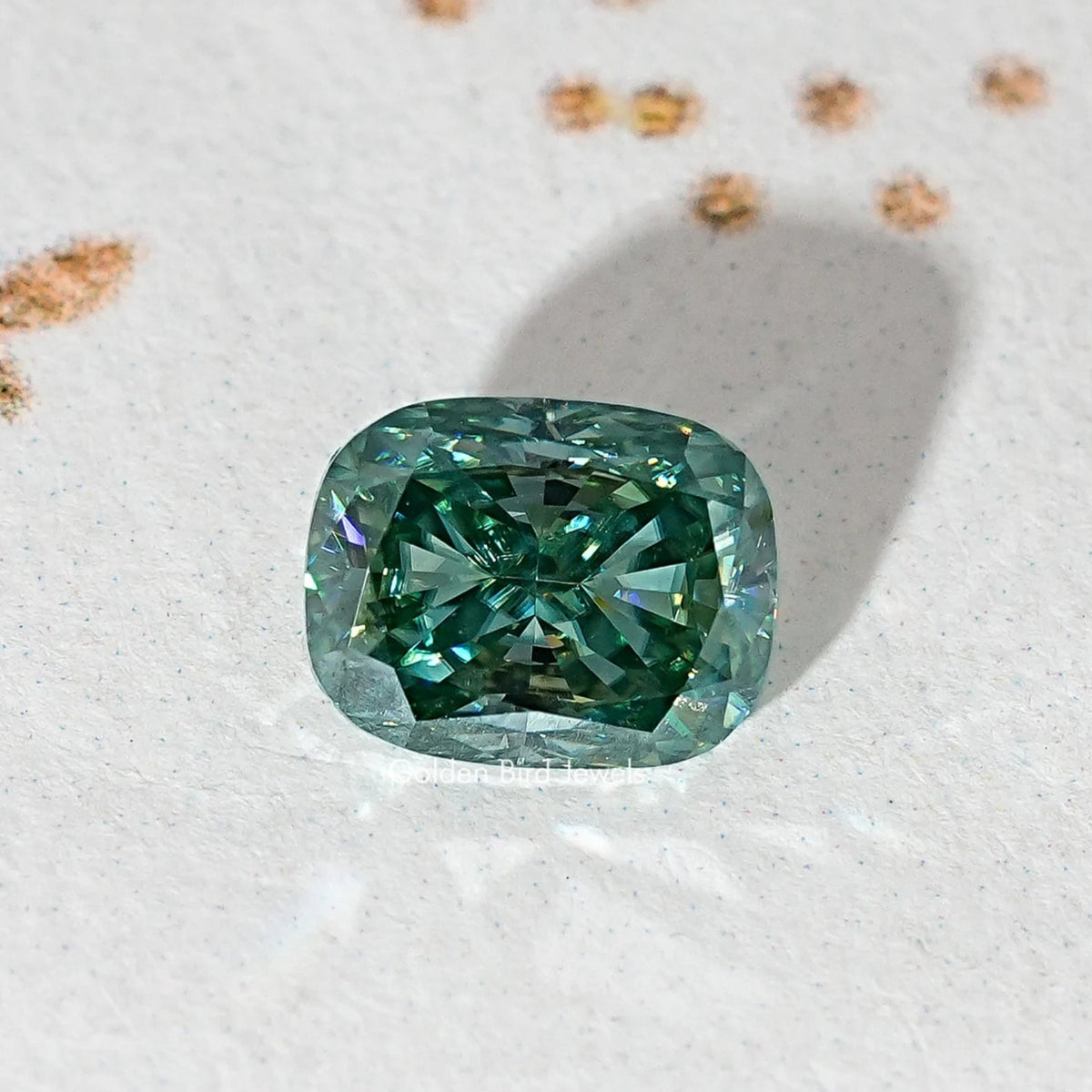 Elongated cushion teal-green moissanite stone, full face view with facets.
