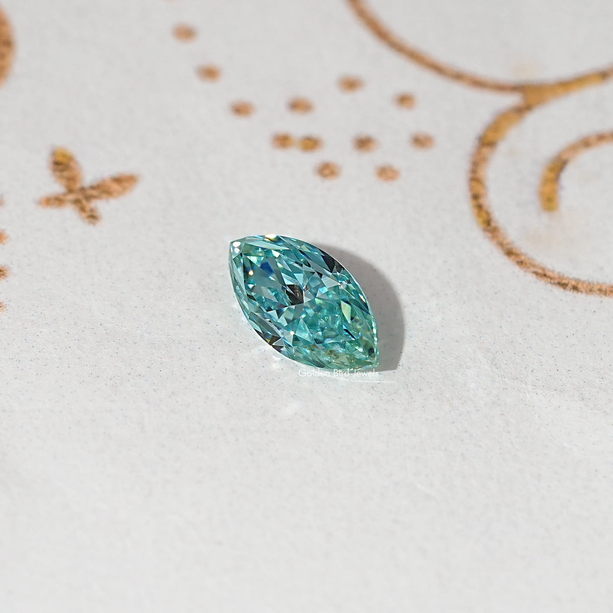 Blue-green marquise-cut loose moissanite gemstone on light gray surface