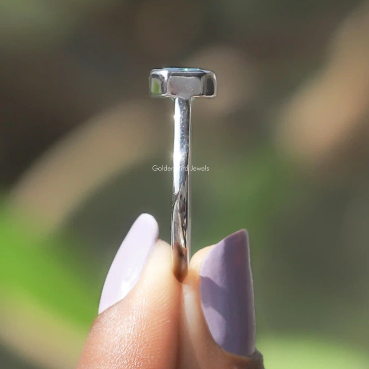 Side View of Radiant Cut Moissanite Engagement Ring In two fingers
