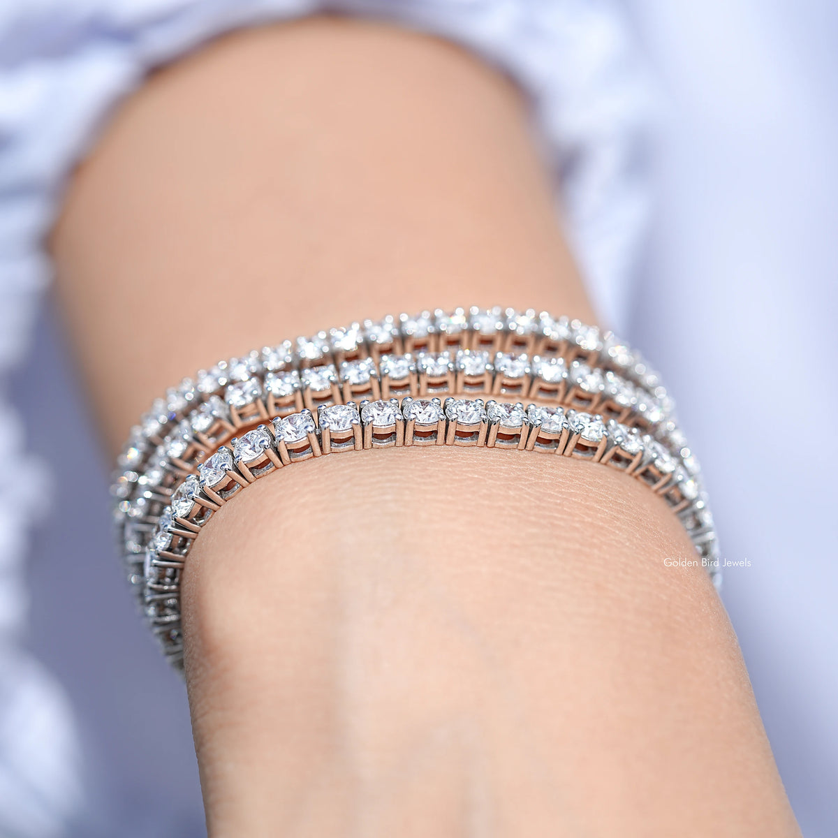 Silver tennis bracelet with round-cut lab diamonds, full top view on wrist