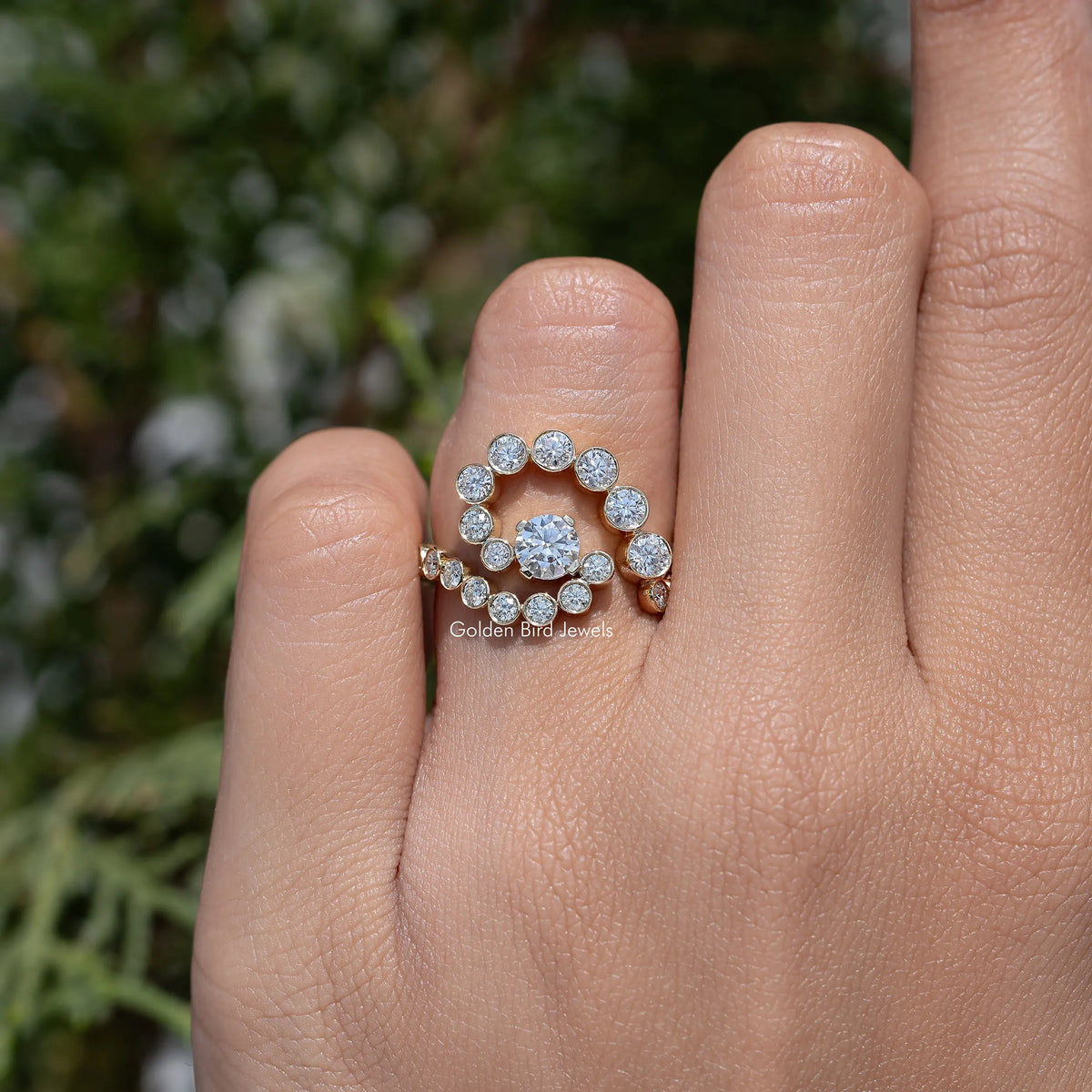 10k yellow gold moissanite ring with circular halo and spiral row of round stones