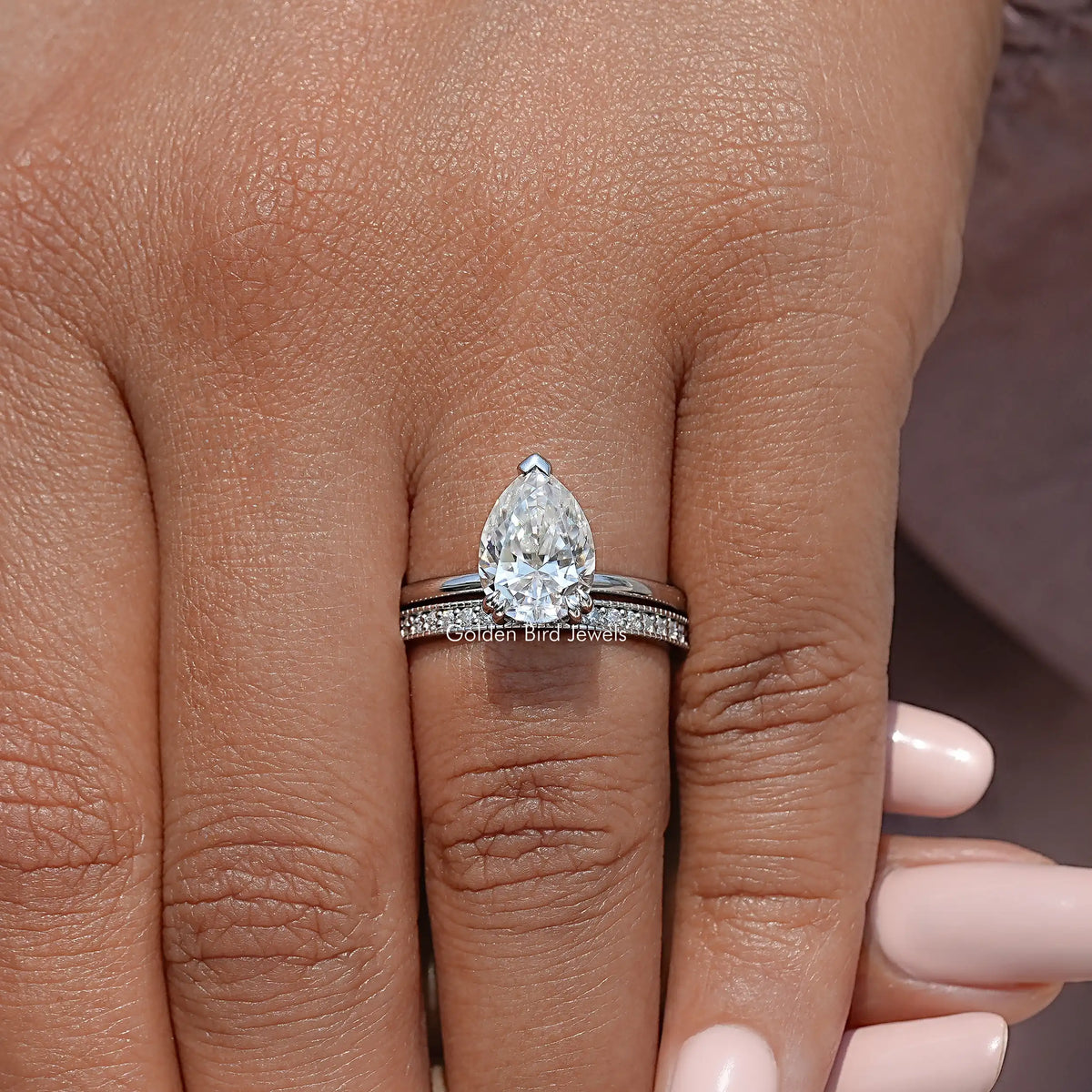 Pear-cut moissanite ring with hidden halo and slim eternity band, silver-tone setting