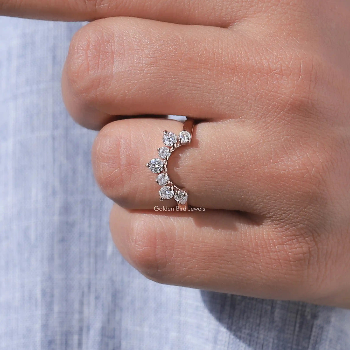 Curved stacking wedding band showing the inner curve and round diamond stones