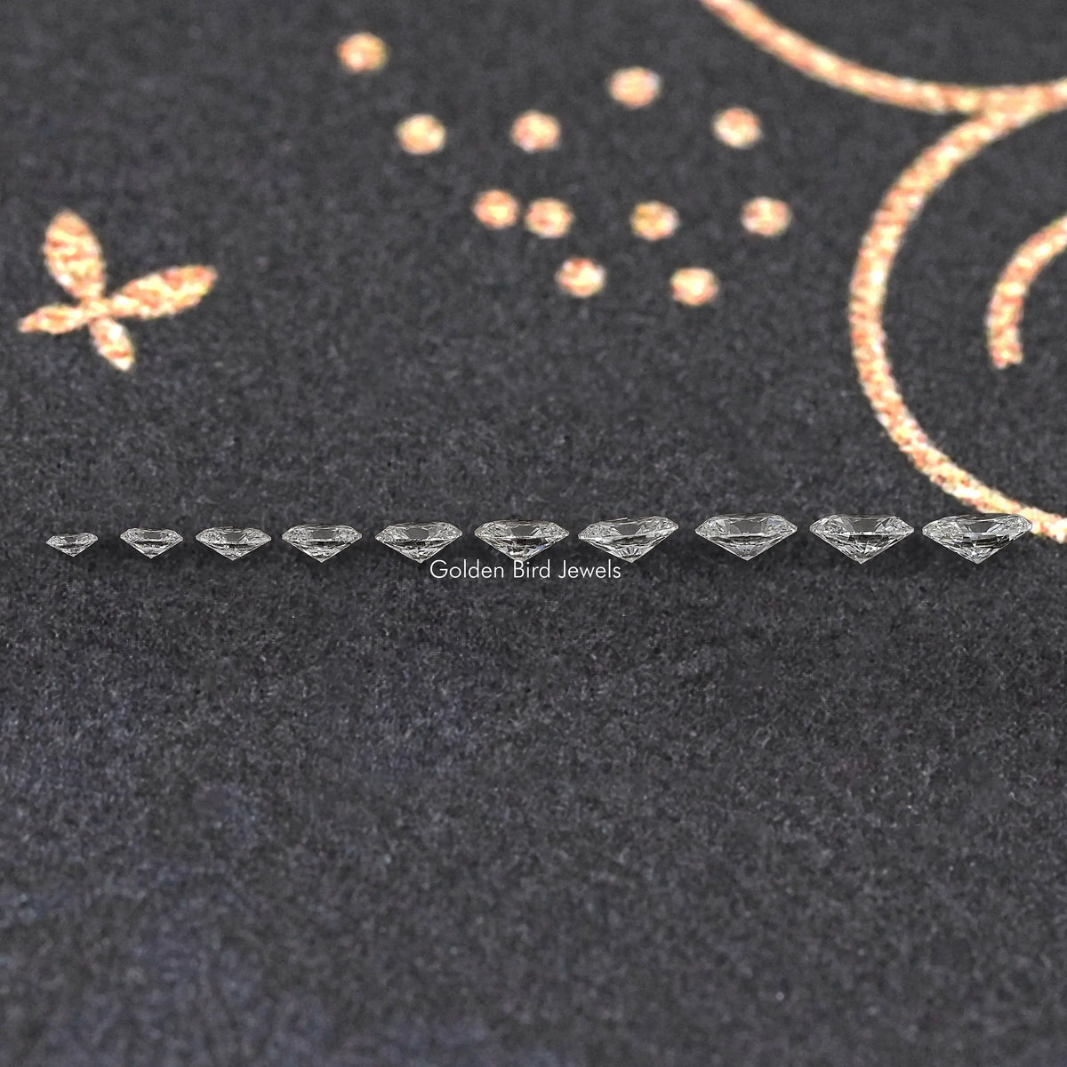 Row of small oval-cut lab-grown diamonds on dark felt display