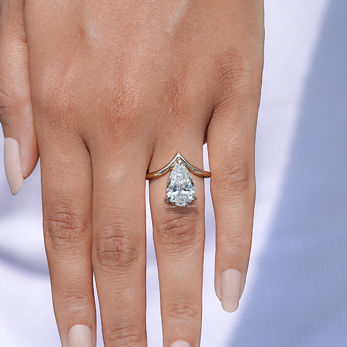 View of Pear cut lab diamond v shaped curved solitaire ring  In Yellow Gold
