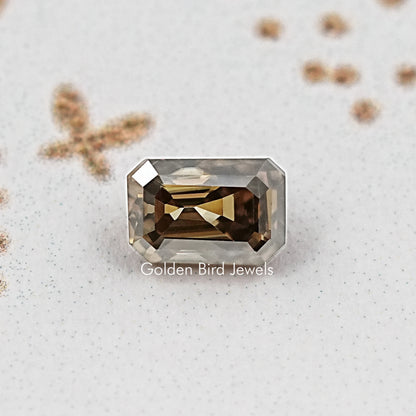 Emerald-cut moissanite loose stone, dark smoky faceted rectangle, close view