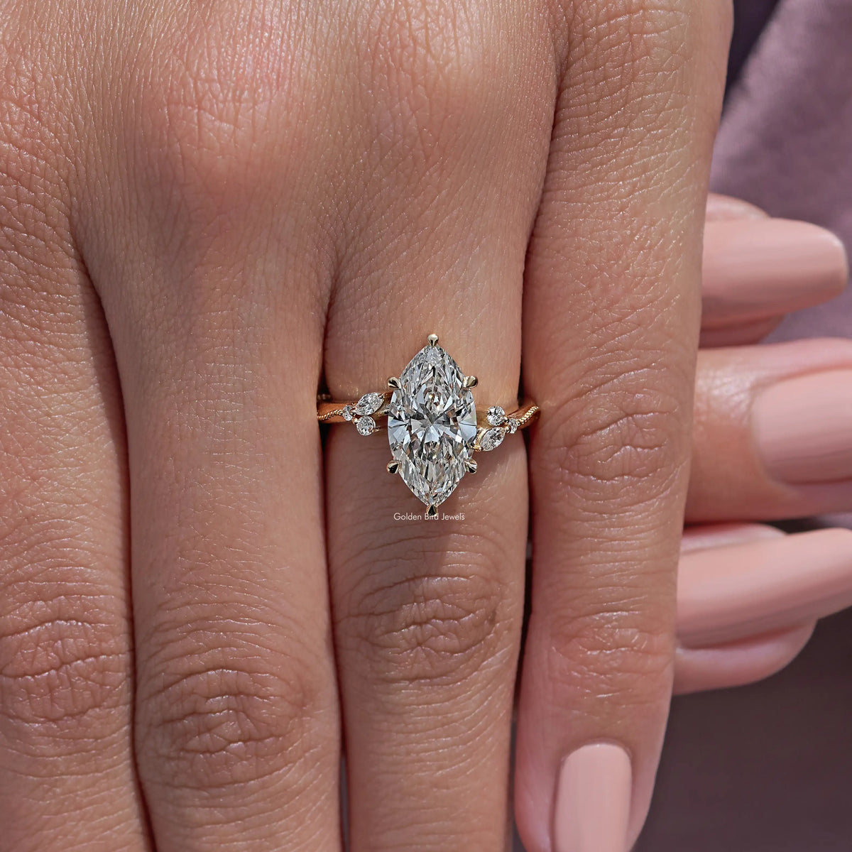 Marquise-cut lab-grown ring with bright center stone and three side accents