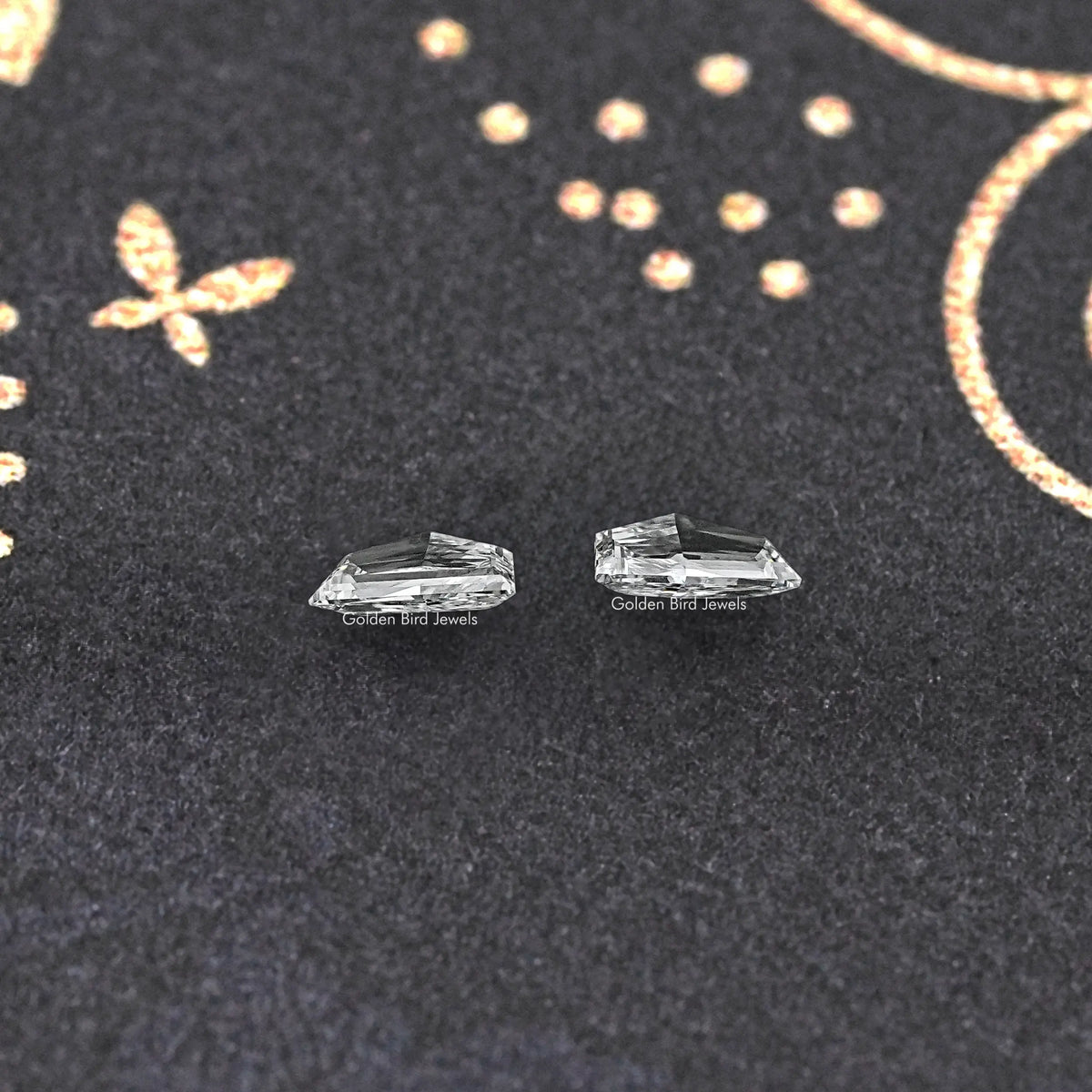 Cadillac-shaped lab-grown loose diamonds pair, clear step-cut facets, side view
