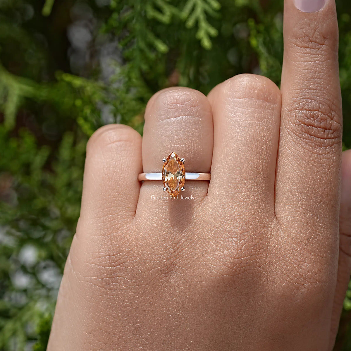Silver ring with marquise-cut orange center stone in four-prong setting