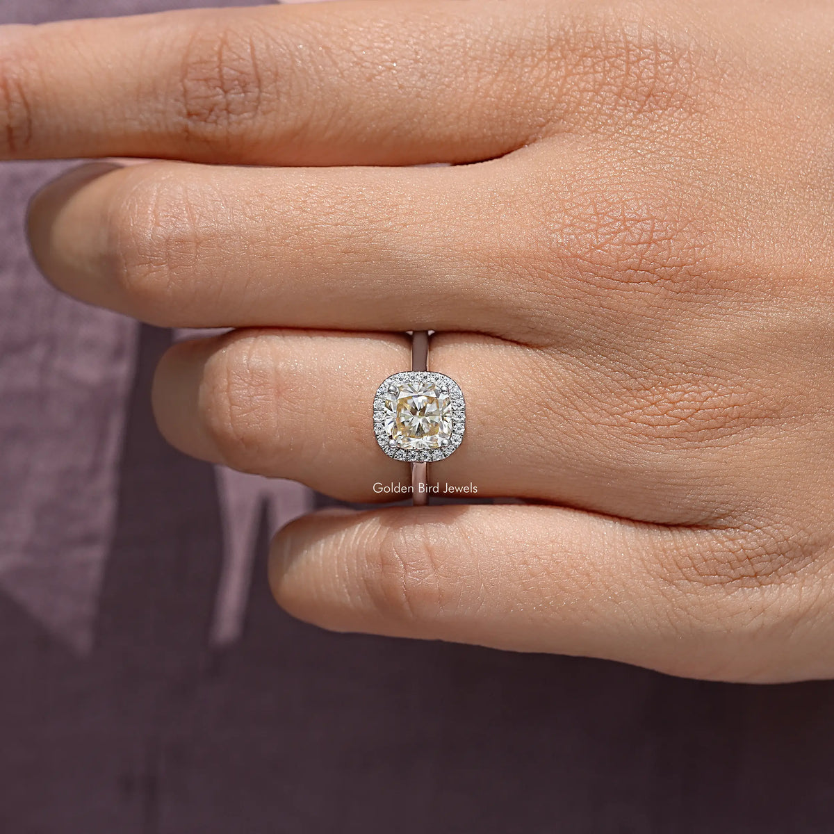 Sterling silver old mine cushion-cut champagne moissanite halo ring on finger