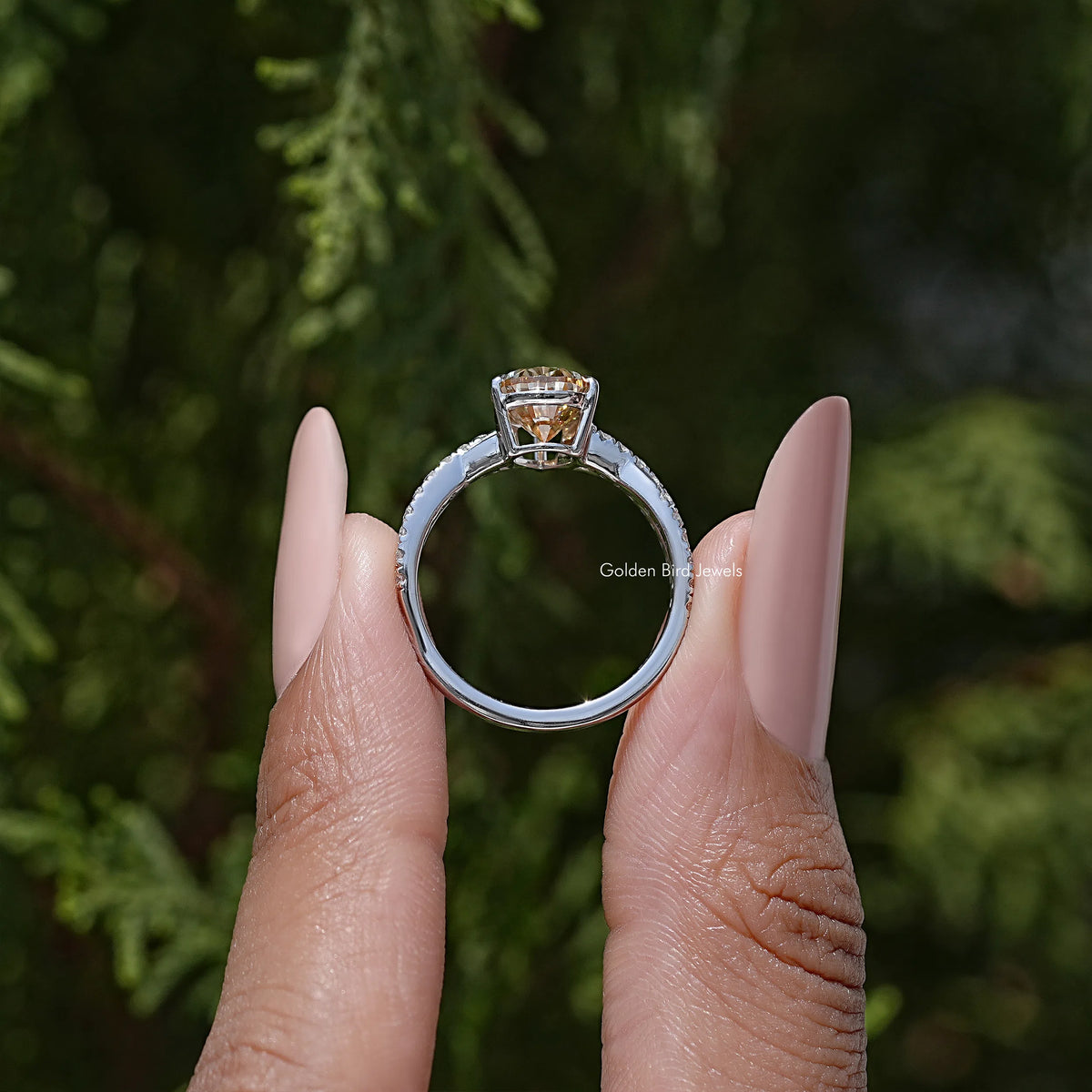 Sterling silver ring with twisted shank and pear-cut moissanite center, prongs visible