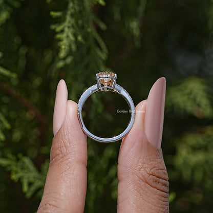 Sterling silver ring with twisted shank and pear-cut moissanite center, prongs visible